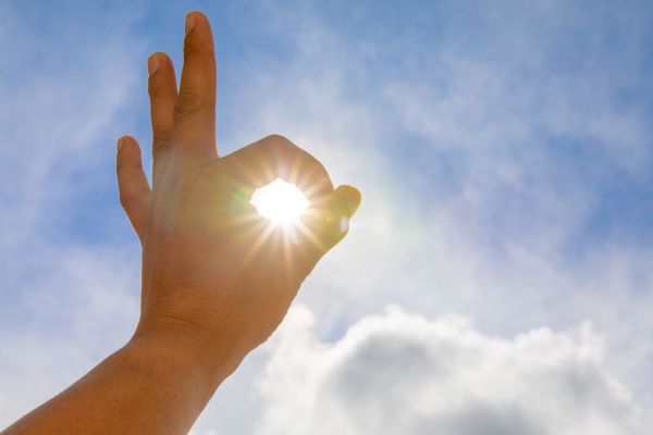 mans-hands-holding-sun-rays.jpg